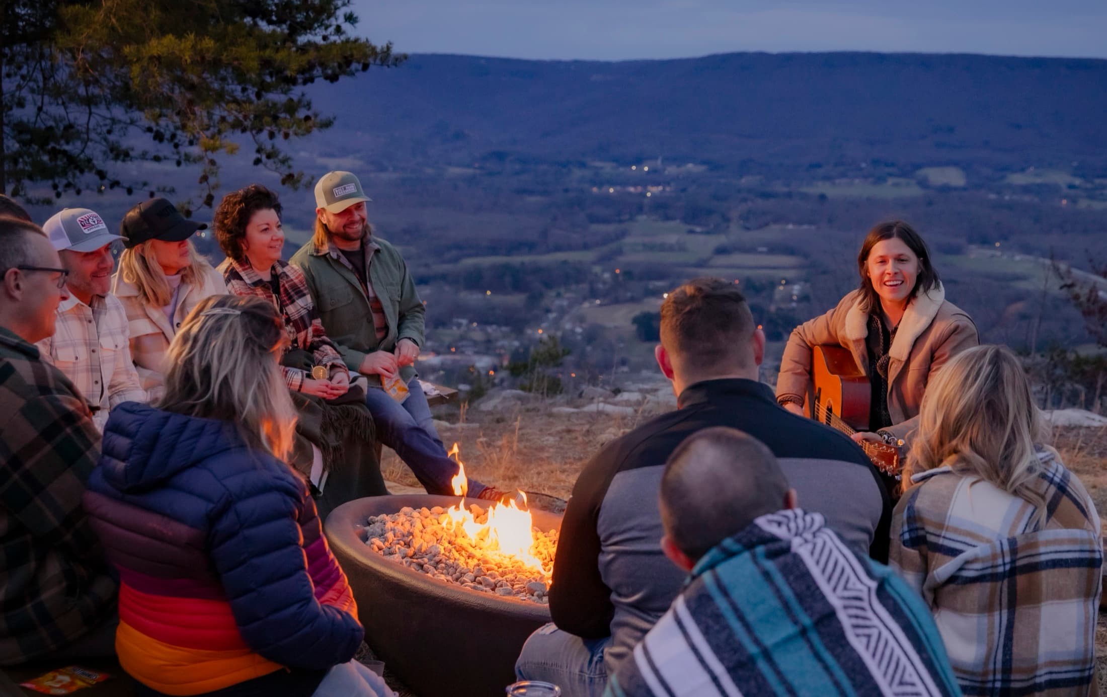 Guests gathered around a firepit at dusk